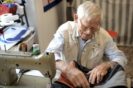 older man sewing