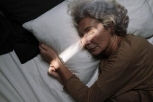 woman sleeping with a beam of sunlight across her face